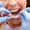 Dentist showing to the female patient how to use mobile orthodontic appliance for dental correction. Close-up.
